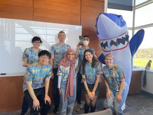 Halloween costumes featuring a shark and Hawaiian shirts. 