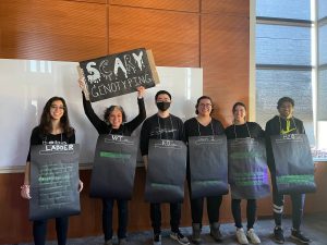 Halloween costumes featuring people dressed in black, gray and green. 
