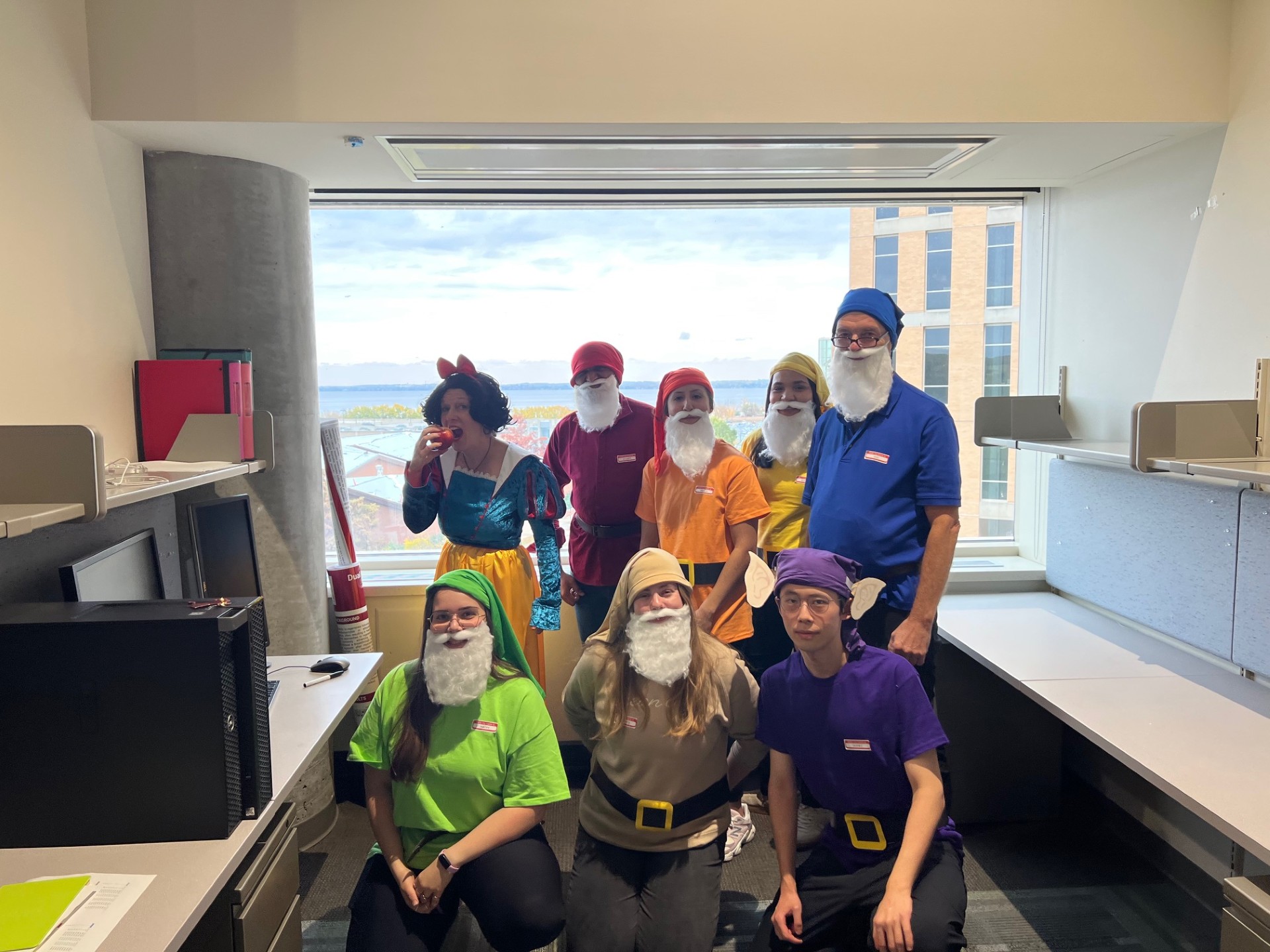 Group of people wearing "Snow White and the Seven Dwarfs"-themed costumes.